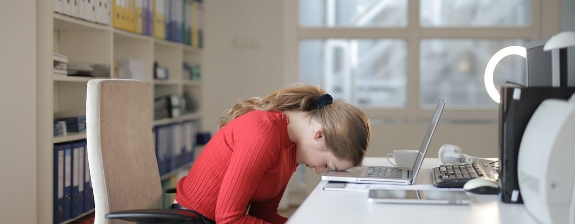 An image showing a girl in stress with laptop