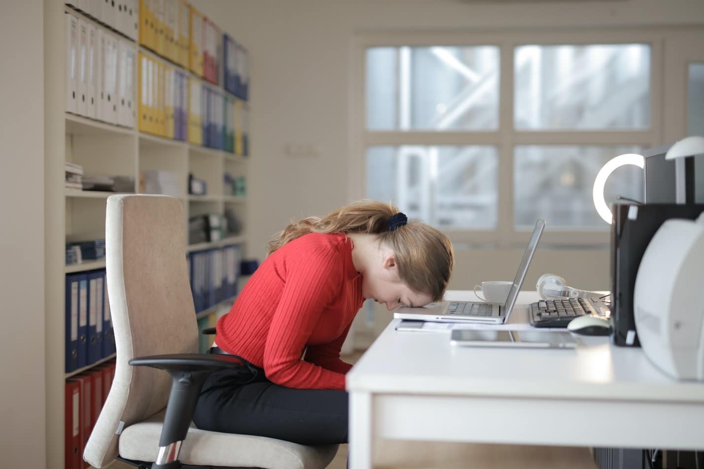 An image showing a girl in stress with laptop