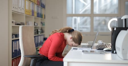 An image showing a girl in stress with laptop